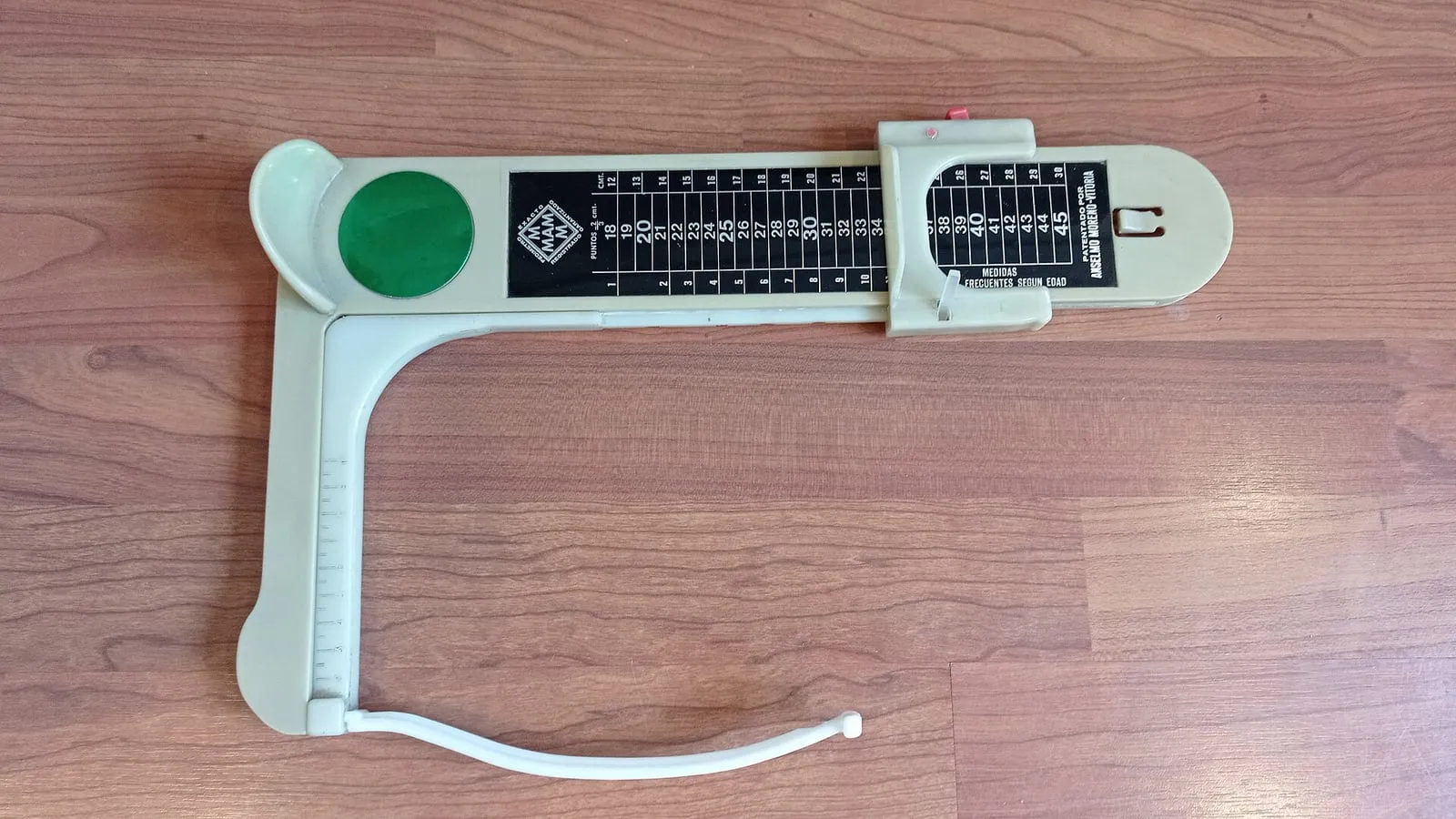 A foot measurement gauge with a foot resting on it