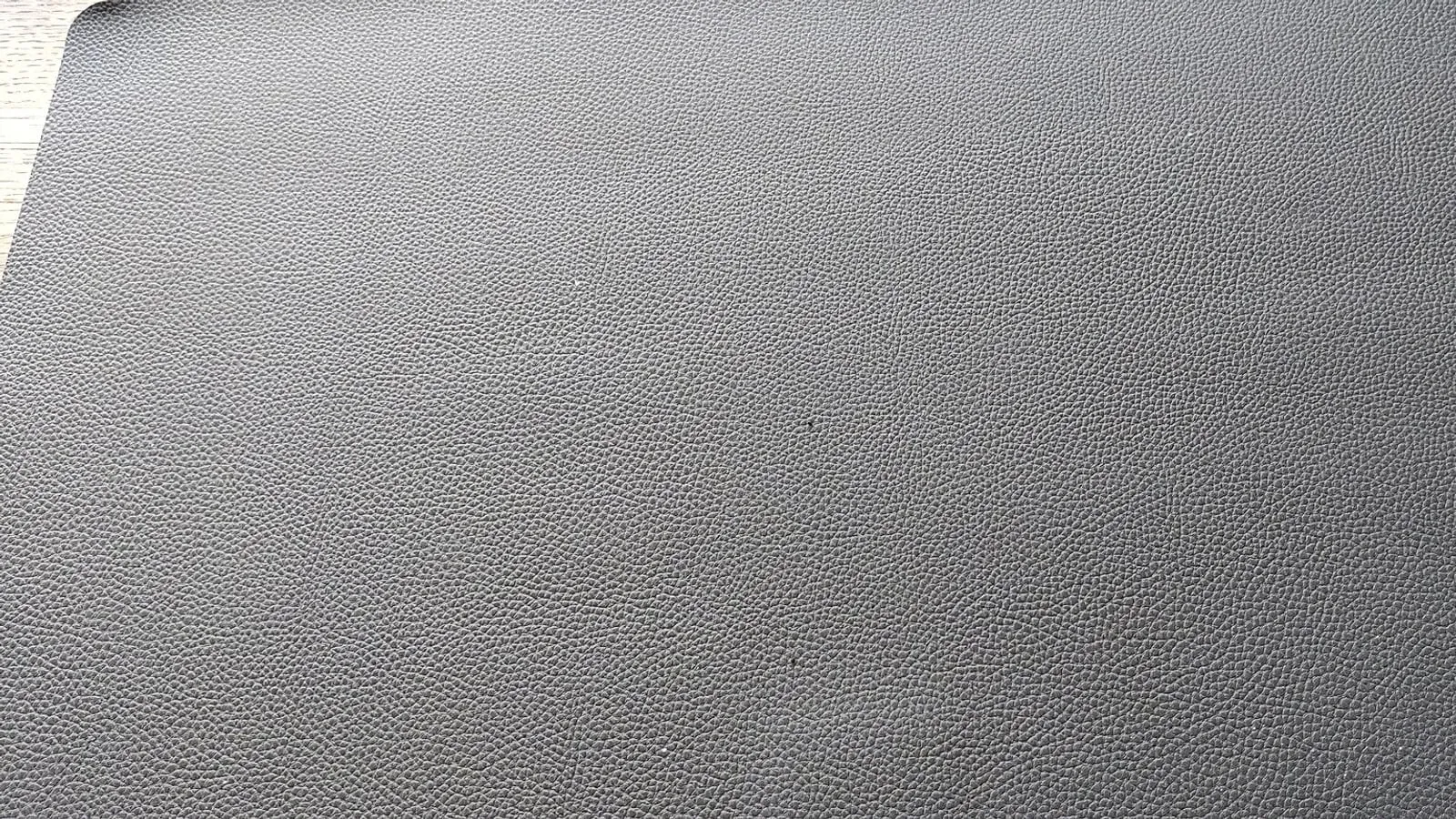 A close view of leather grain beside a synthetic fabric